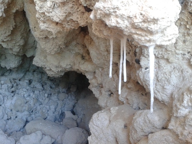 White stalactites hanging from a limestone sea cave ceiling on a Loreto island snorkeling tour