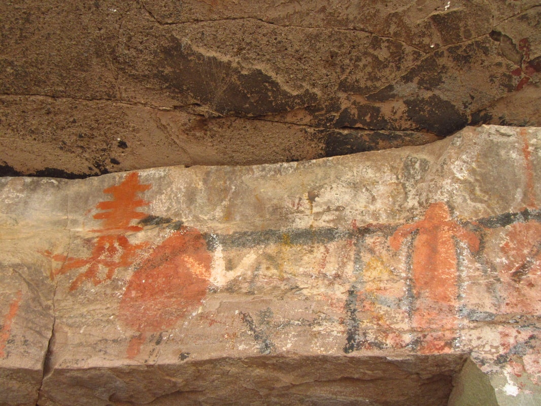 Ancient cave paintings with red ochre figures on rock ledge, Sierra de la Giganta near Mission San Javier