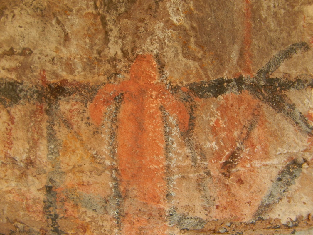Ancient cave painting of large ochre human figure on stone wall, Sierra de la Giganta near Mission San Javier